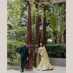 A stylish pose by the couple. The bride's soft glam makeup and flowing gown create a romantic and modern feel.