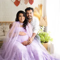 A classic portrait of an expecting couple. The flowing lavender gown and the warm, natural light create a soft and romantic feel for this maternity memory.
