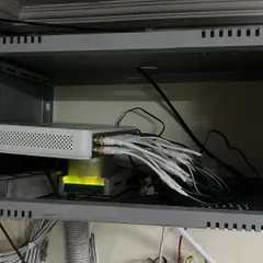 An improperly stored DVR with tangled connections. This can cause overheating and signal loss, which is why our DVR cleaning service is a critical part of maintenance.