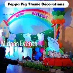 Here you can see the birthday boy enjoying his Peppa Pig themed party. The setup includes large character cutouts and his name in big, bold letters, making him the star of the show.