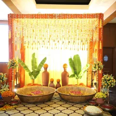 A traditional South Indian themed setup perfect for a Haldi ceremony. I used authentic elements like banana leaves, earthen matkas, and large woven baskets, all tied together with the auspicious colors of orange and yellow from marigold flowers.