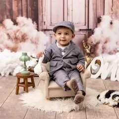 Dressed to impress for his first birthday! We style unique themed portraits like this "Little Gentleman" setup, complete with vintage-inspired props and outfits, to perfectly capture your baby's budding personality.