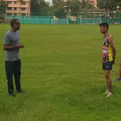 Head coach Dayanand Shetty providing post-workout feedback and correction to an athlete, a key part of our personalized coaching approach.