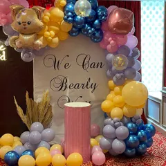 A closer look at the "We Can Bearly Wait" backdrop, showing the custom calligraphy and the detailed balloon arch with a cute cat foil balloon.