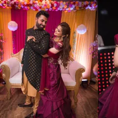 A beautiful moment from a Roka or engagement party. The couple shares a dance, lost in their own world, with a colorful and festive decor behind them.