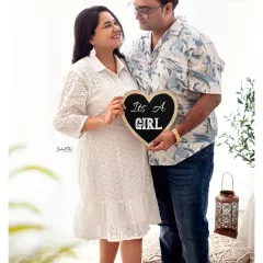 A beautiful announcement from this sweet couple. The "It's a Girl" sign combined with their happy smiles makes for a perfect pregnancy announcement photo.