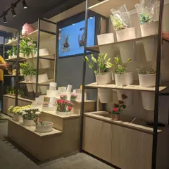 The multi-level display units we designed for FnP. This tiered setup allows for a variety of products, from small bouquets to larger plants, to be displayed attractively and accessibly.