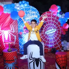 The birthday boy, Ayushman, enjoying his special Spiderman themed setup. We design our decorations to be a perfect photo opportunity for creating lasting memories.