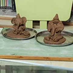 Two finished clay Ganeshas, each with its own unique personality. Our workshops celebrate individuality and creativity.