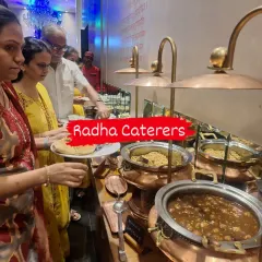 Guests helping themselves to a variety of main courses at a birthday celebration. Our buffet includes diverse options like Hakka noodles and traditional vegetable curries to satisfy every palate.