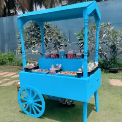 A whimsical candy cart, painted in the party's signature blue. It was filled with colorful treats and sweets, becoming a favorite spot for the little guests.