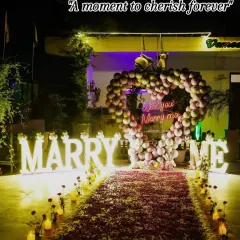 A moment to cherish forever. The warm glow of the marquee letters and the candlelit rose petal aisle created an incredibly romantic atmosphere for this heartfelt proposal.