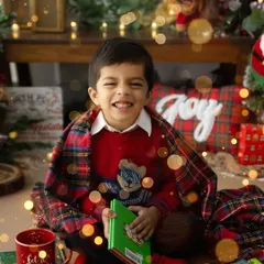 The pure, uncontainable joy of the holiday season. This little one's smile during a Christmas mini session is a perfect example of the warm, magical memories we can create together.