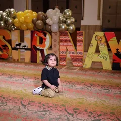 The birthday boy, Shrinay, sitting in front of his personalized 'Lion King' themed name display. I focus on creating these special moments that you and your family will cherish forever.