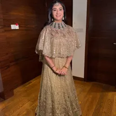 A full-length view of this graceful Sufi night look. The makeup is understated, allowing her natural beauty and the detailed outfit to shine.