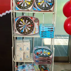 A selection of dart boards and board games ready to be given out as prizes or party favors at a superhero-themed event.
