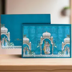I love bringing traditional art forms to life, like in this Pichwai-themed invitation box. The vibrant teal and intricate illustrations of Radha and Krishna create a piece that is both culturally rich and modern in its presentation.