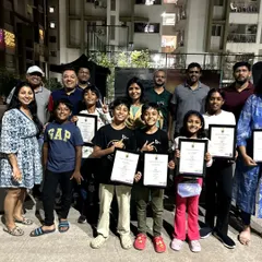 A group photo from our "Champion's Meet" in Hyderabad. Our students and their proud parents gather together, holding certificates from Trinity College London. This is the supportive community that fuels our students' success.