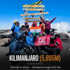 The summit of Kilimanjaro, the roof of Africa. This is a moment of pure triumph for our team, celebrating with the Indian flag after a challenging climb. We guide expeditions to the Seven Summits, making global dreams a reality.