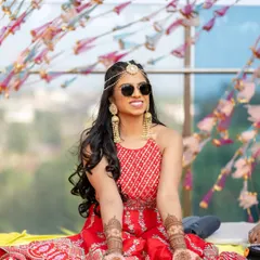 Mehendi magic with a cool pair of sunglasses. This bride is all about having fun, and her makeup is bright and shimmery to match her vibe.