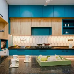 We believe functional spaces can also be joyful. This kitchen design uses a bold peacock blue, balanced with the warmth of rubberwood cabinets and a spacious black granite breakfast counter, creating an energetic yet practical heart of the home.
