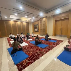 An instructor demonstrates a pranayama (breathing technique) to the staff at Radisson Hotel. These simple yet powerful exercises can be easily integrated into a daily routine to manage stress.