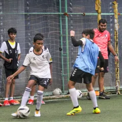 A coach oversees a competitive drill, ensuring players are using the correct technique while maintaining a high level of intensity.