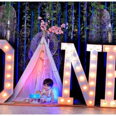 Celebrate your baby's first milestone with a memorable cake smash or birthday photoshoot. We provide themed setups like this one, complete with large 'ONE' marquee letters and a safe, fun environment for your little one.