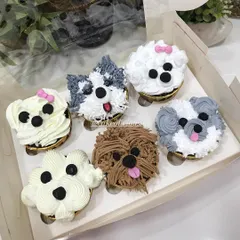 A set of six puppy-faced cupcakes, each with a unique design and expression. I use different piping techniques to create realistic fur textures, making them an adorable treat for any dog lover.