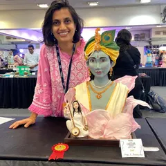 Posing proudly with my Krishna and Meera Bai sculpted cake that won the gold award. This piece was a labor of love, combining intricate modeling and storytelling.