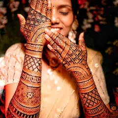 An artistic shot of the bride with her stained hands. The dark, crisp lines of the checkerboard pattern show the precision of the application and the quality of the stain.