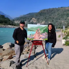 Us with our finished artwork by the Ganga in Rishikesh. This destination wedding was a dream, combining nature's beauty with a beautiful celebration.