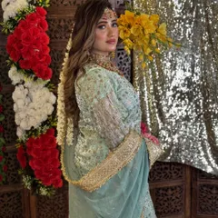 A beautiful portrait of the model, showcasing her soft glam makeup and the intricate details of her outfit and jewelry for this pre-wedding themed shoot.