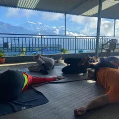 A moment of rest during a yoga retreat in Nepal. After an active practice, taking time for Savasana or guided relaxation is essential for integrating the benefits and rejuvenating the body.