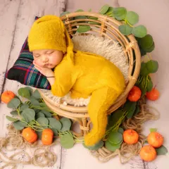 I love using natural textures and warm colors, like this mustard yellow outfit and rattan basket. It creates a cozy, autumnal feel while keeping the focus on your peacefully sleeping baby.