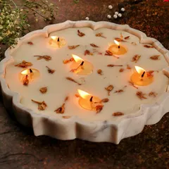 My 9-inch Lotus Marble Urli Candle is designed to be more than just a light source; it's a statement centerpiece. I hand-pour multiple wicks of soy wax into a beautifully carved marble urli, creating a luxurious piece that transforms any festive space.