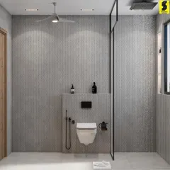 The other side of the washroom shows the minimalist walk-in shower area with a sleek glass partition. The continuous grey chevron tiles create a soothing and spacious feel.
