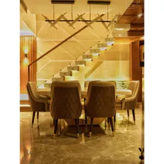 This dining space is defined by the striking modern staircase behind it. We used a combination of wood, glass, and recessed lighting to make the staircase a functional sculpture, creating a dramatic backdrop for family meals and gatherings.