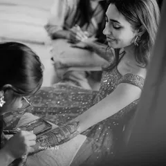 In my element, completely focused on the art. This black and white shot captures the intimate process of creating a custom mehendi design for a client.