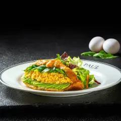 A gourmet scrambled egg and avocado croissant sandwich, elegantly plated and shot against a dark, moody background for Paul.