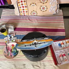 Here is a look at my setup for the airplane painting. A quick weekend project that was so much fun to create on this wooden canvas. You can see my paints, palette, and the artwork in progress.