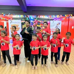Our instructor stands proudly with a group of young Taekwondo students from our April batch summer camp. This class focuses on teaching basic stances and techniques in a supportive environment.