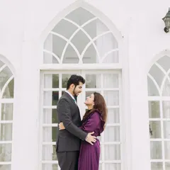 An elegant portrait in front of a white chapel-style building. This backdrop adds a touch of classic romance and sophistication to the pre-wedding shoot.