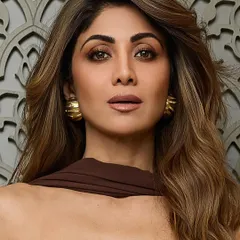 A close-up of Shilpa Shetty's hair and makeup, showing how the warm brown tones in her hair beautifully complement her complexion.