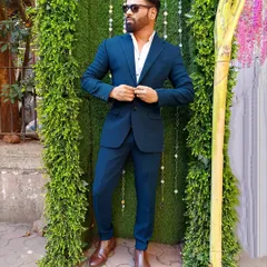 A classic and sharp look with a well-fitted blue suit. This demonstrates my ability to dress formally for any high-end corporate or wedding function.