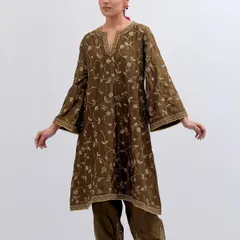 This olive green kurta set is a masterpiece of grace. The all-over floral vine embroidery in gold thread creates a look that is both earthy and regal.