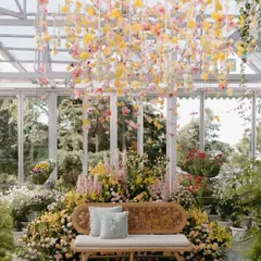 A Haldi ceremony set inside a sun-drenched greenhouse in Mussoorie. I used a delicate canopy of hanging orchids and a garden of yellow and pink blooms to create a space that felt fresh, joyful, and effortlessly beautiful.