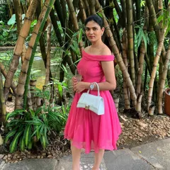 A perfect dress for a birthday or daytime party. I designed this piece in a bright pink fabric with a classic off-the-shoulder neckline and a flared, knee-length skirt for a fun and feminine look.
