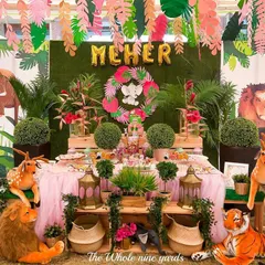 A "Wild, free & three" safari party for a little jungle explorer. The dessert table was surrounded by plush safari animals and lush greenery to create a friendly and adventurous jungle scene.