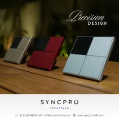 Our SyncPro keypads are designed with precision to complement your decor. Here you can see the same model in three different metallic finishes: silver, red, and champagne, all sitting on a wooden surface.